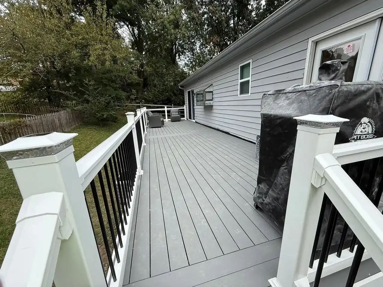 Composite deck build with white railings on Southern Maryland home — Crossroads Contracting LLC
