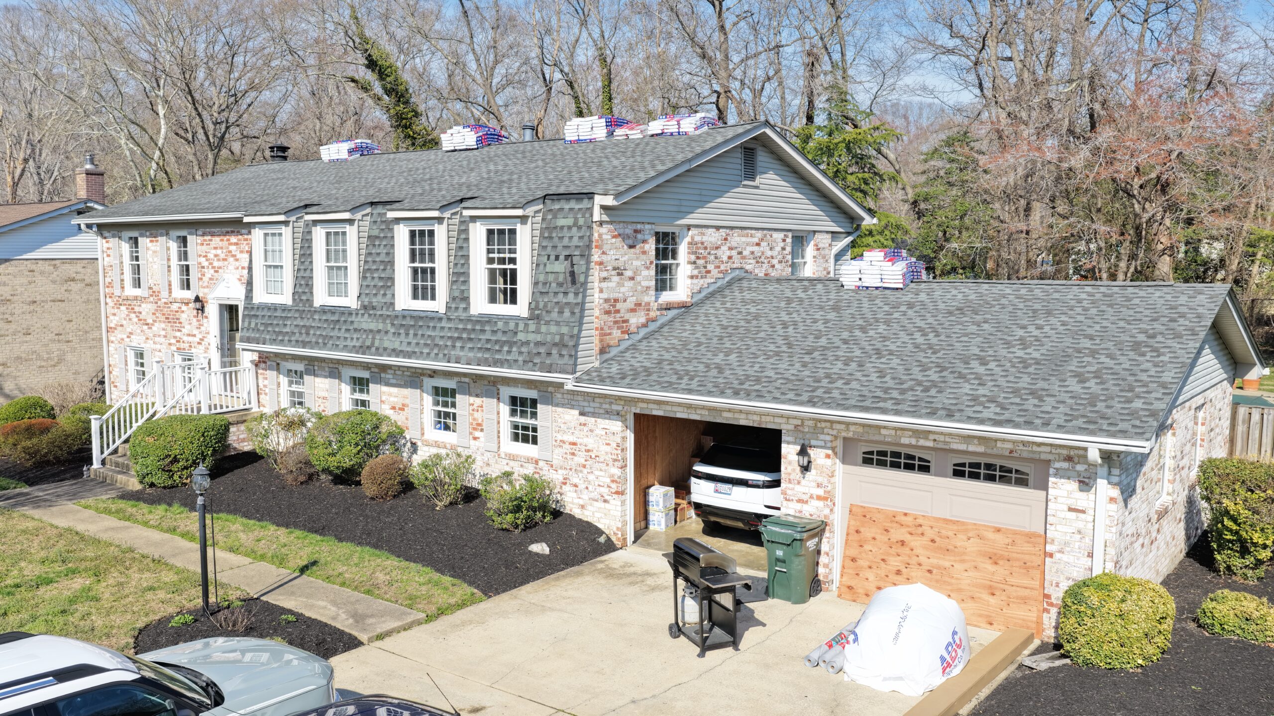 Drone aerial view of asphalt shingle roof replacement in progress Southern Maryland — Crossroads Contracting LLC