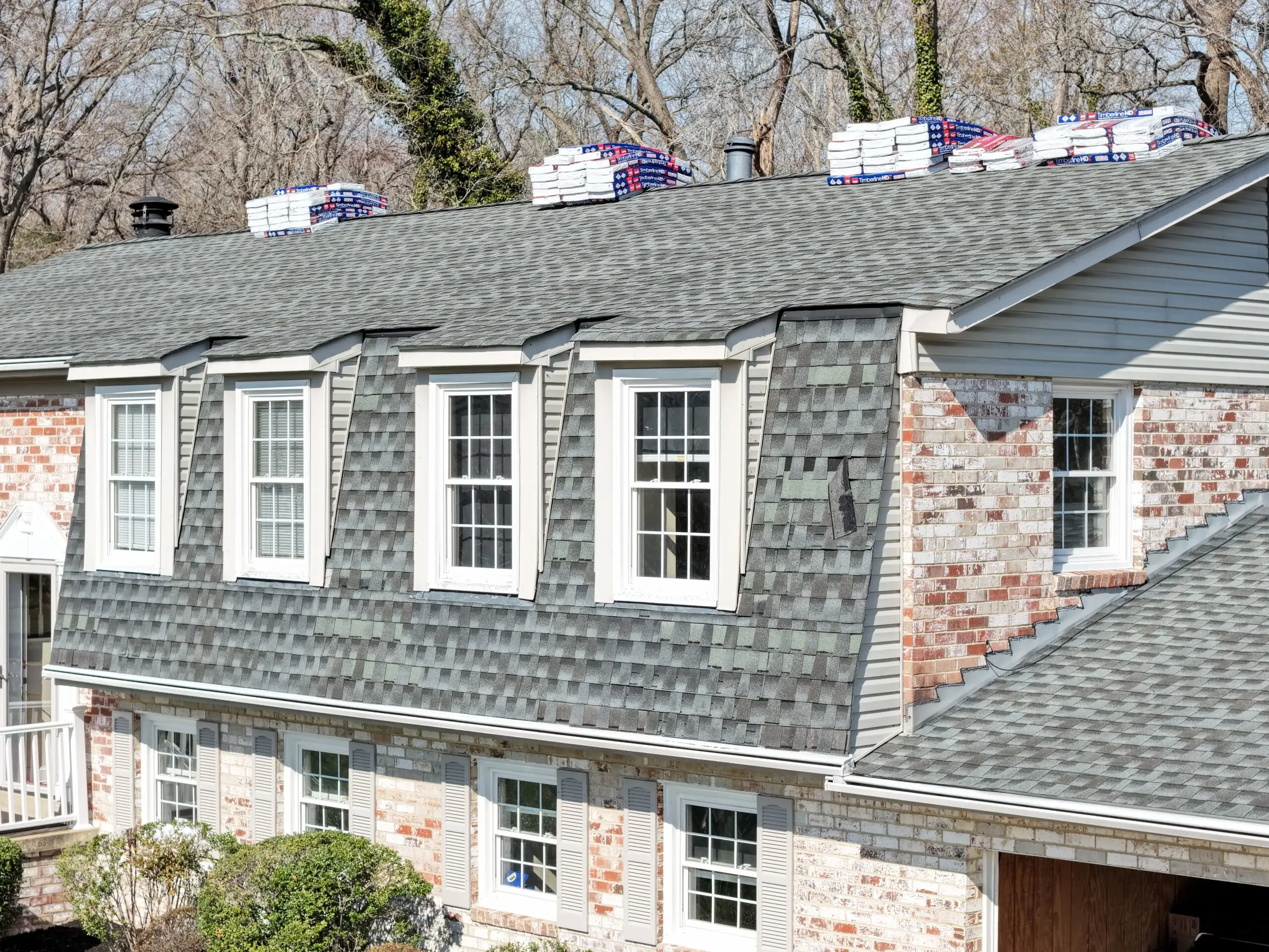 Drone aerial shot of vinyl siding replacement underway on Southern Maryland home Crossroads Contracting LLC