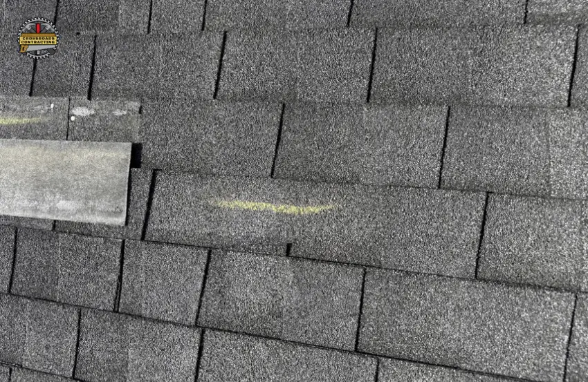 Roof shingles curling at the edges due to aging and weather exposure